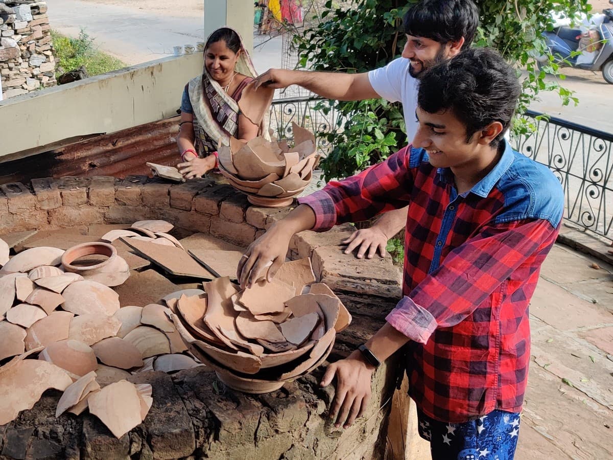 Mohit Kumhar, Dinesh Chandra Kumhar, Kailash Devi, and Umesh Kumhar preparing the bhatti kiln