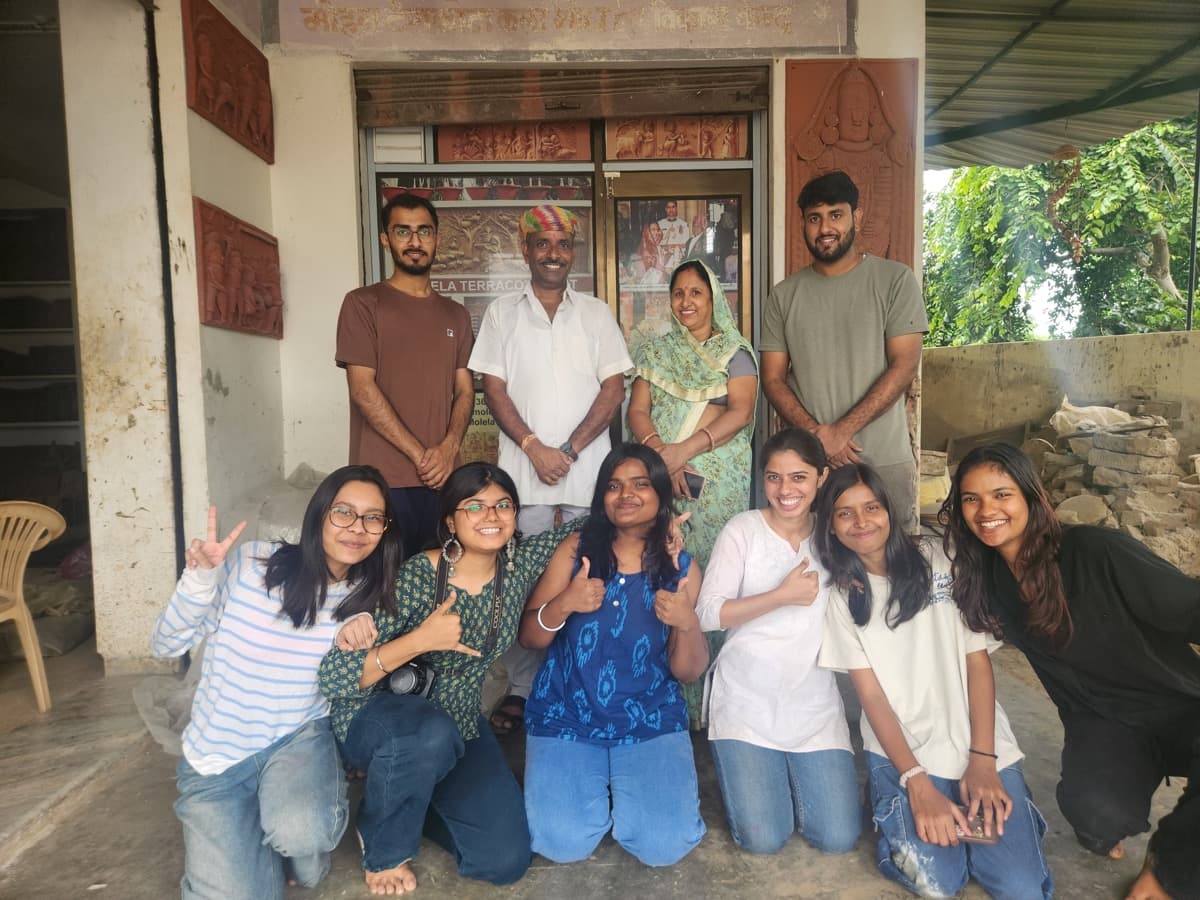 Umesh Kumhar, Dinesh Chandra Kumhar, Kailash Devi, and Mohit Kumhar hosting design students in Molela