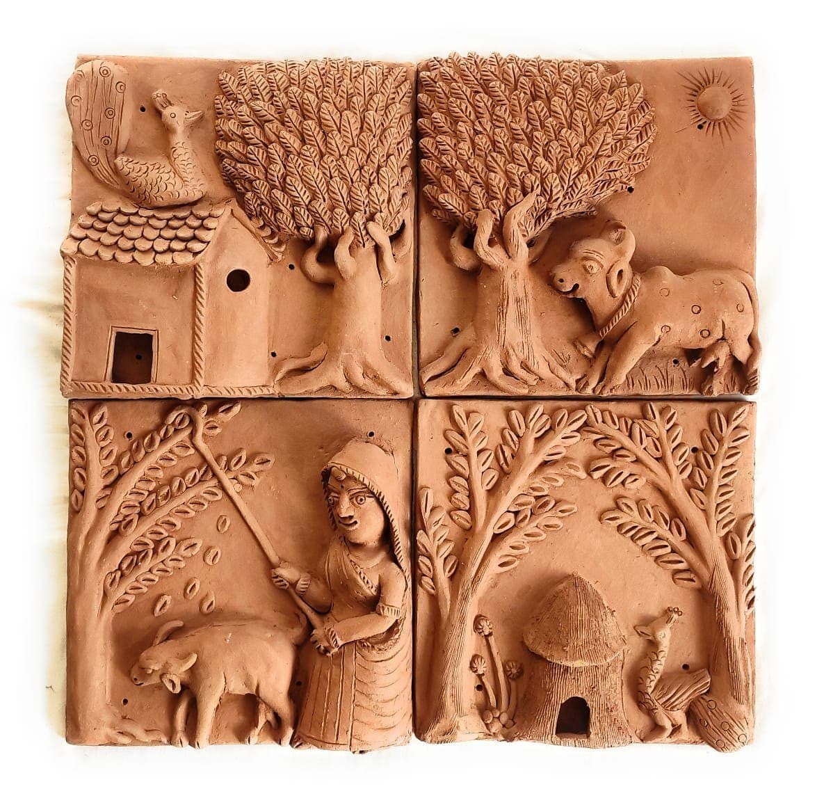 Set of four miniature terracotta clay tiles with nature motifs
