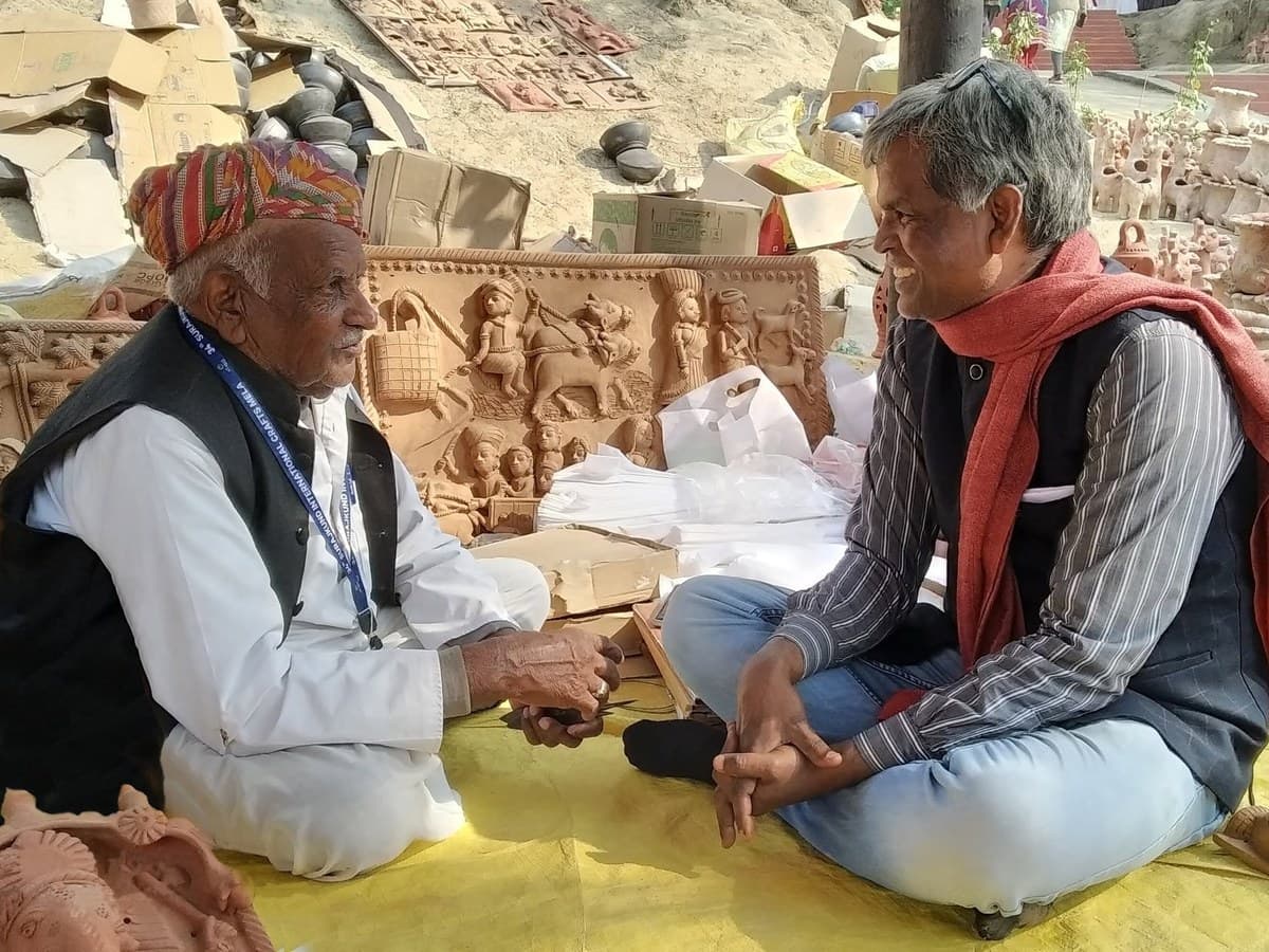 Mohan Lal Kumhar and Dinesh Chandra Kumhar exhibiting handcrafted terracotta plaques at Surajkund Crafts Mela