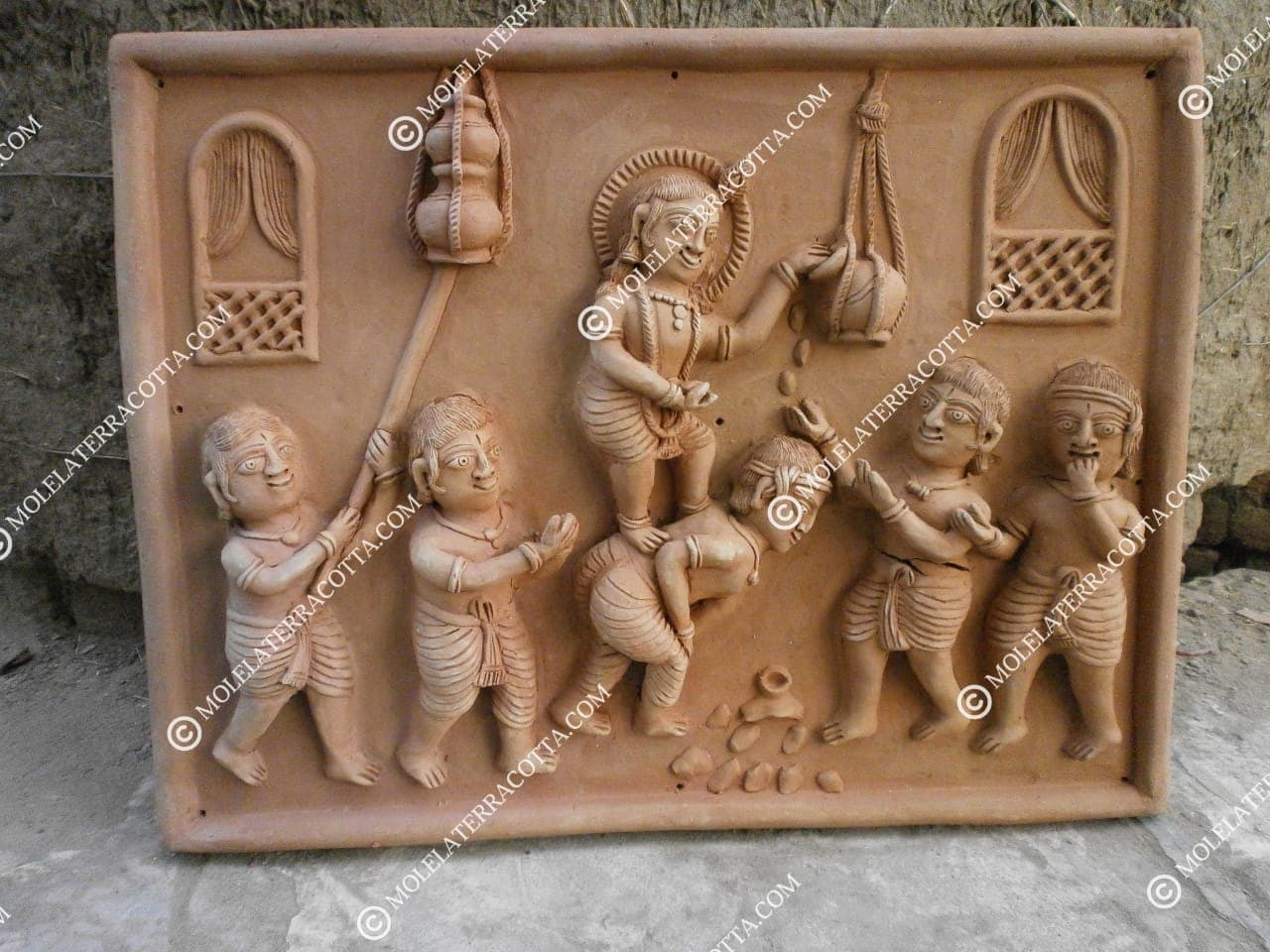 Handmade terracotta relief panel depicting Bal Krishna stealing butter with friends